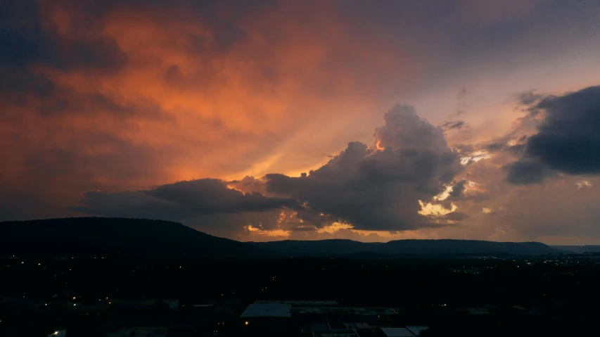 the sun is setting behind a colorful cloud