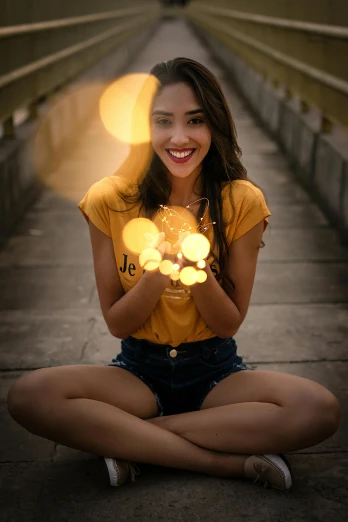 a young woman in short shorts and a t - shirt holding some lights