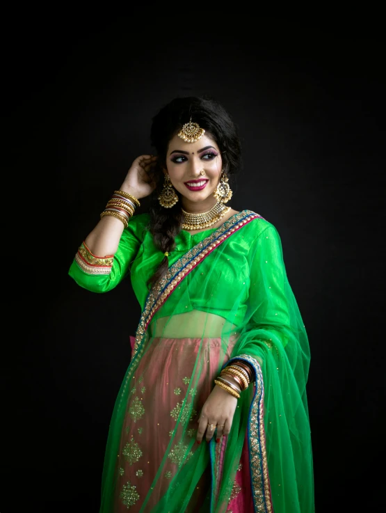 an indian woman wearing a sari and holding a handbag