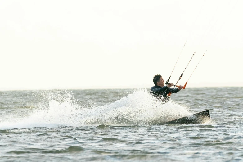 a person on the water being pulled by a wind surfboard