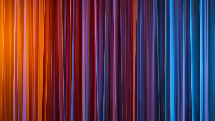 a rainbow - colored curtain is lit by light