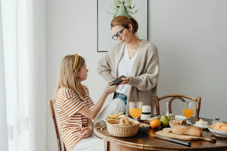 two women are preparing their meal at a table