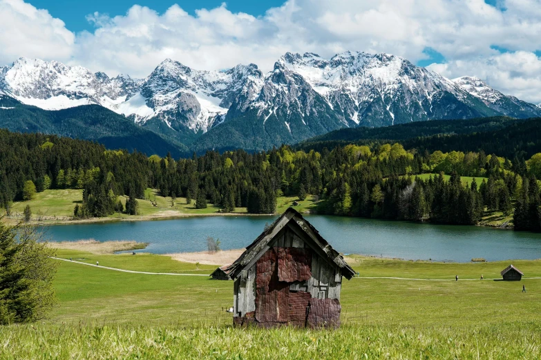 a hut that is in a green field