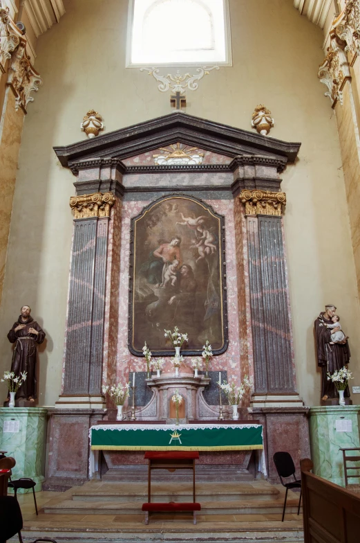 a large stone alter in a church with gold and blue detailing