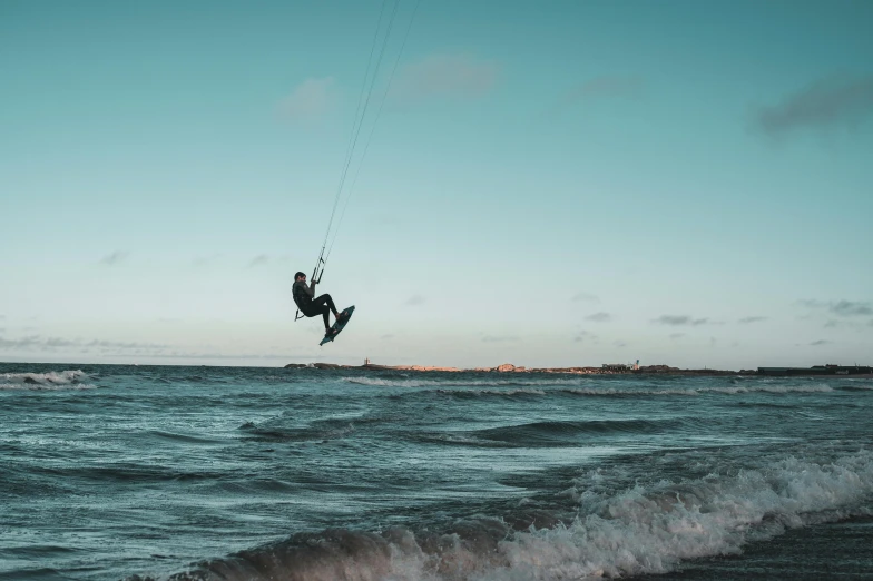 man being pulled in the air while para sailing