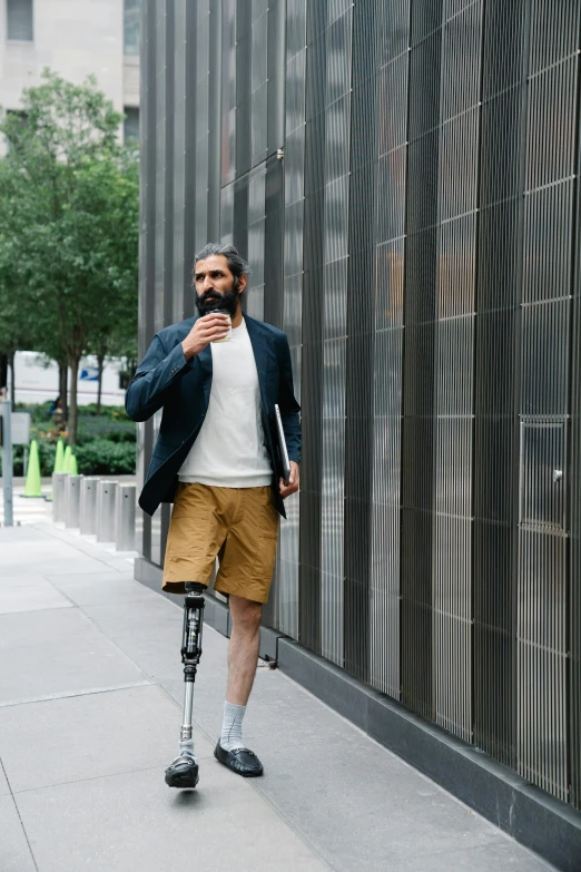 man using an adjustable walker as he walks down the street
