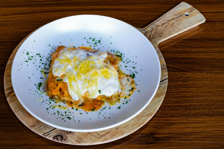 a dish on a table with a wooden serving board