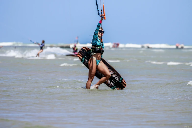 a person holding a kite and a surf board