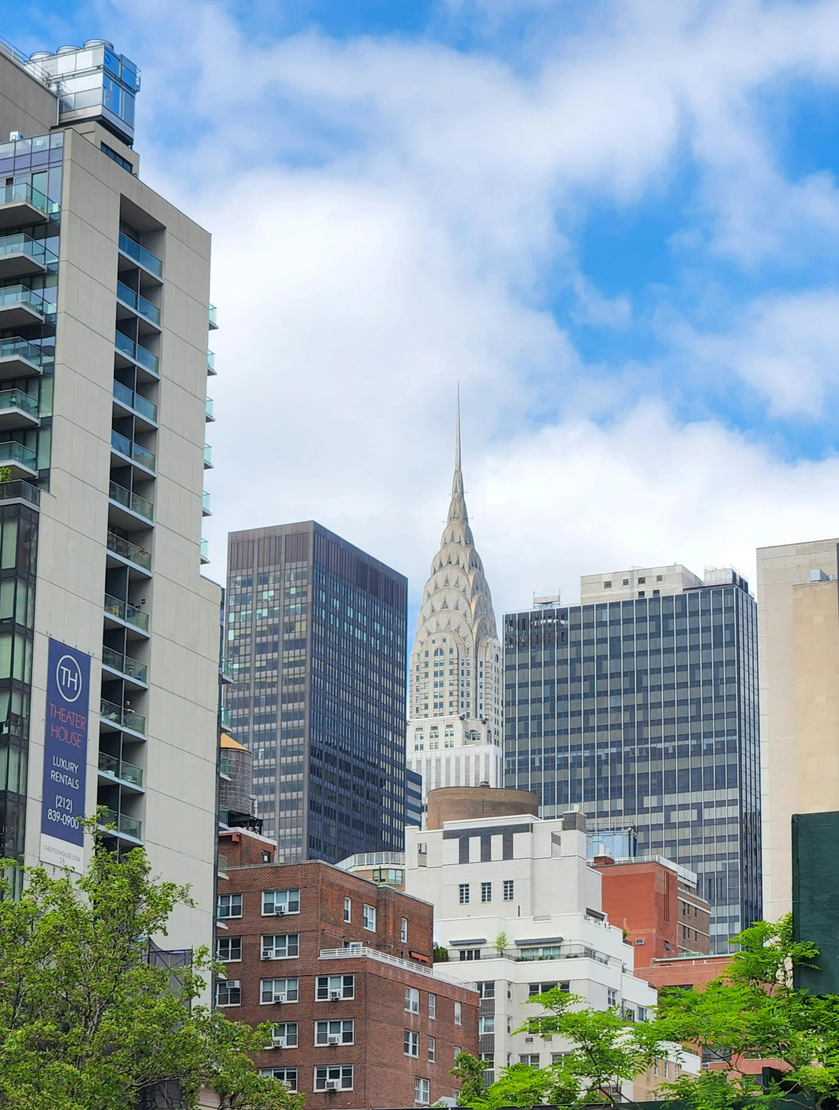 a group of buildings with trees in front