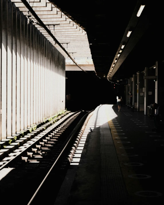 an empty train station with several tracks running through it