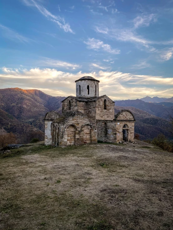 old, abandoned church in the mountains above a lake