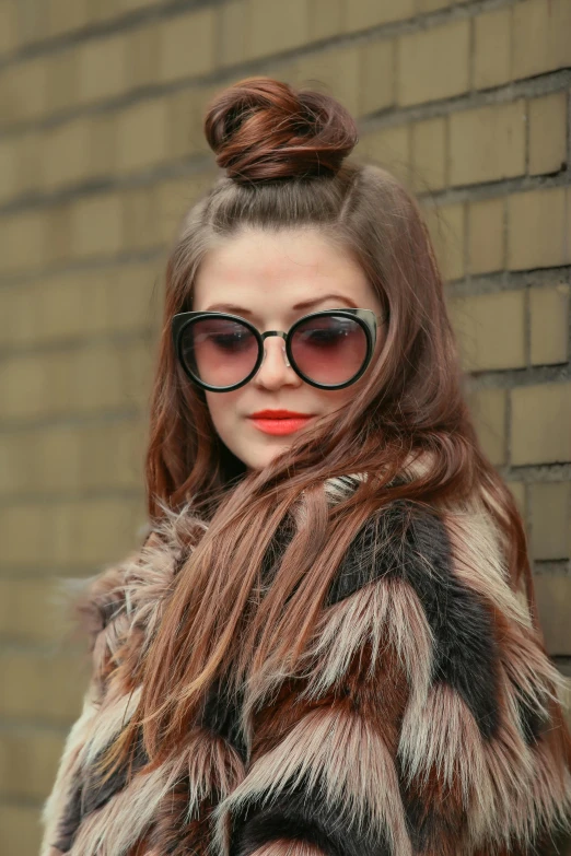 a woman with a ponytail is dressed in sunglasses