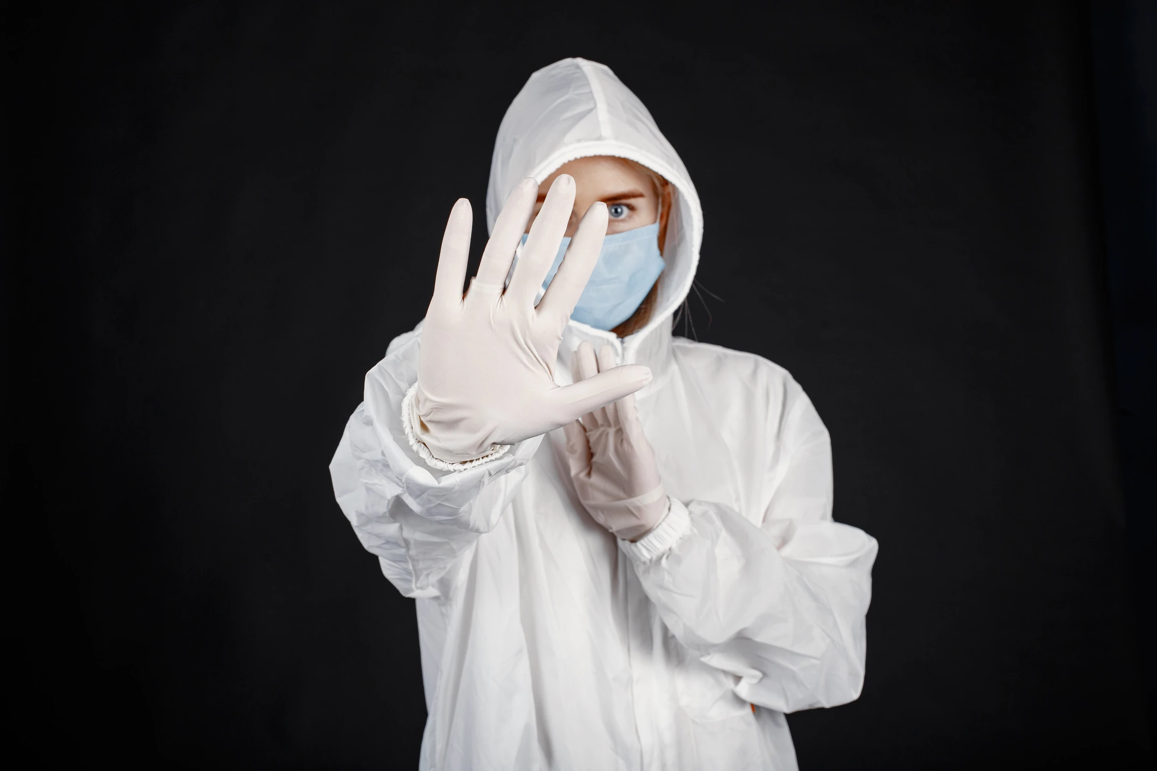 a person wearing a protective suit and a mask covering their face