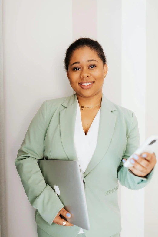 an african american woman standing against a wall with her arms out