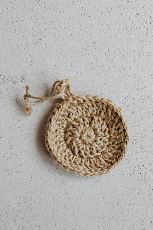 a crochet basket sitting on the floor