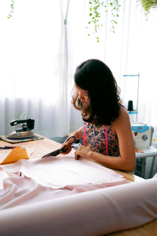 a woman is making some art work with wood