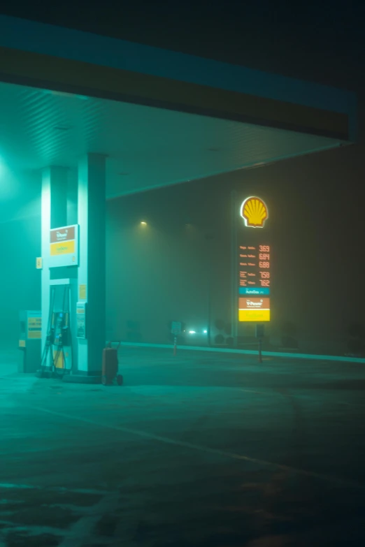 a gas station with a green glow on it's side