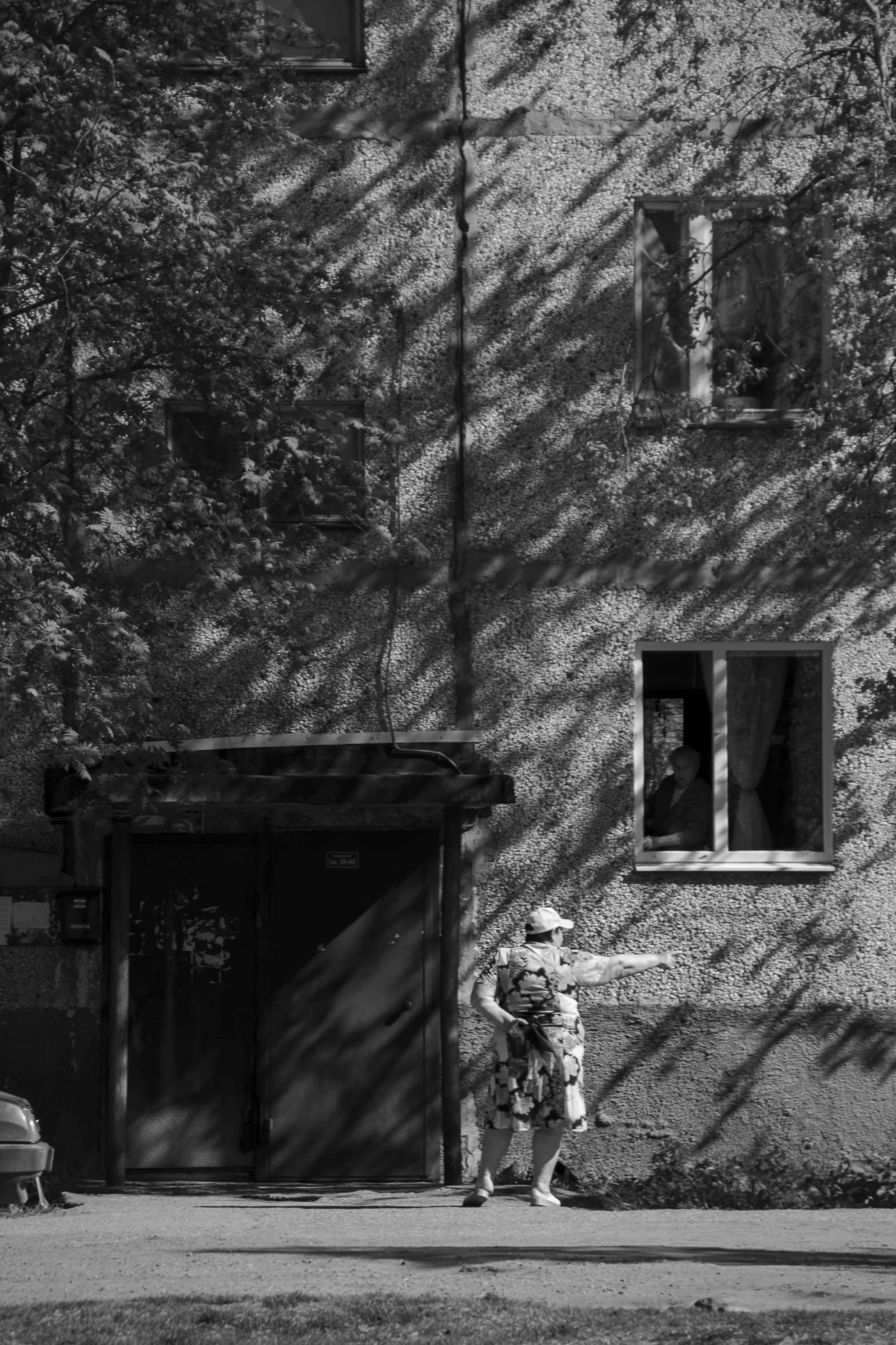 a little girl walking past a tall building