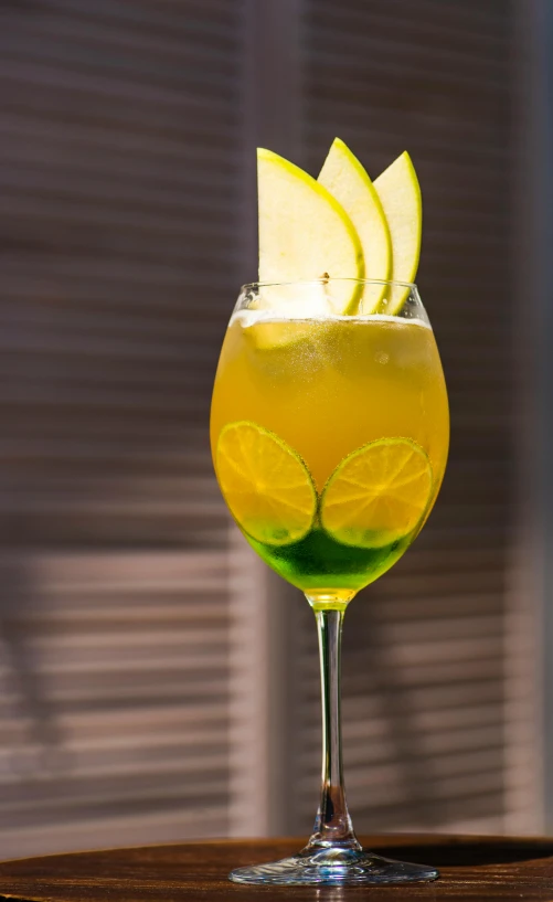 a drink with a cut lemon wedge in the garnish