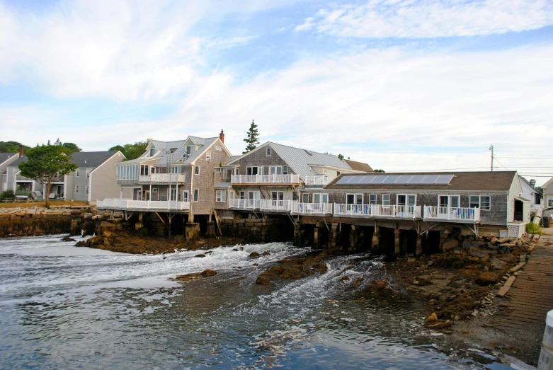 a house sits by a pier that has houses on the side