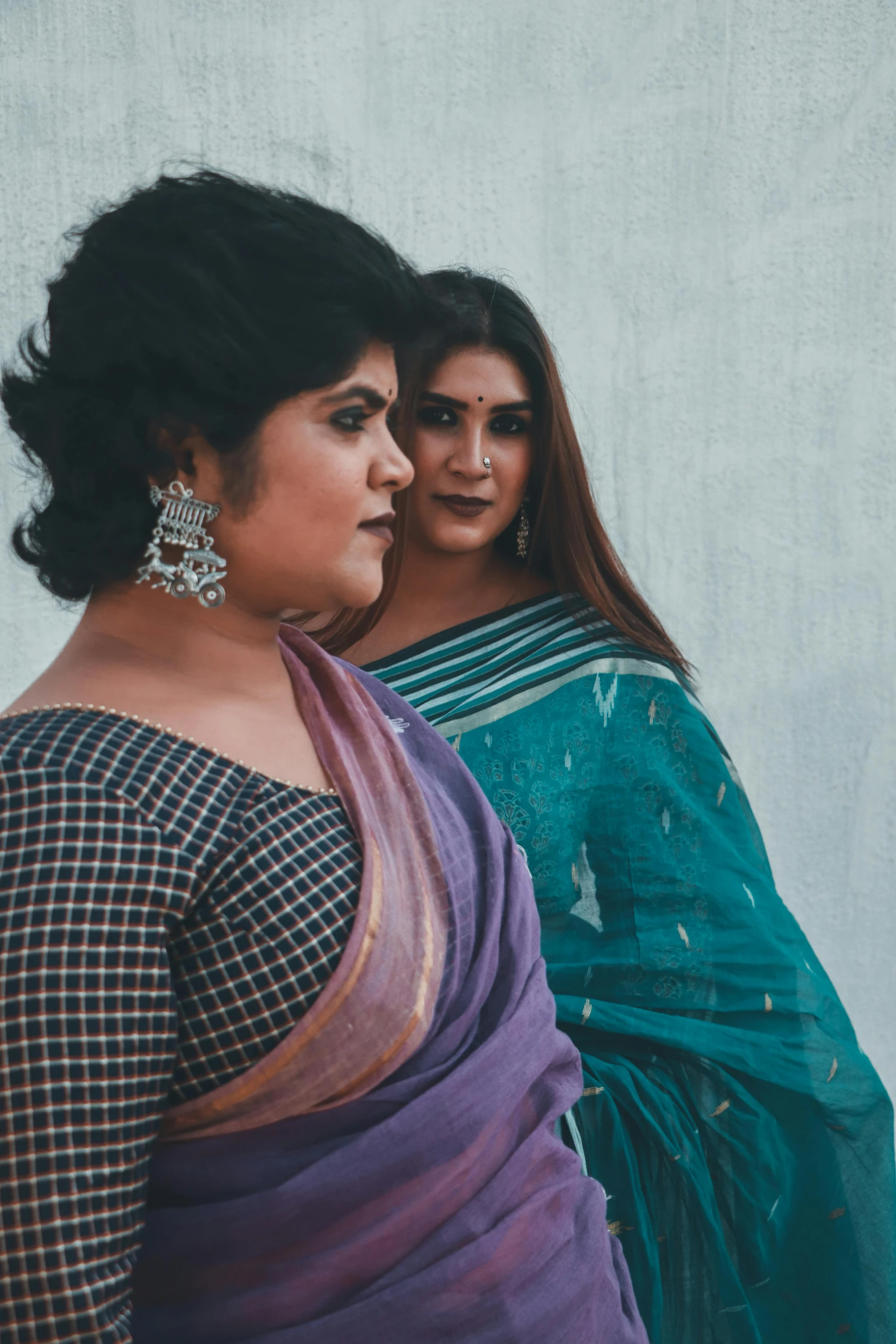 two women in traditional indian attire emcing each other