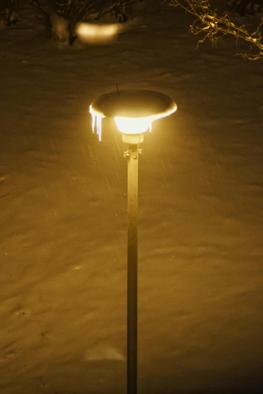 street lamp with illuminated circular object in snowy area