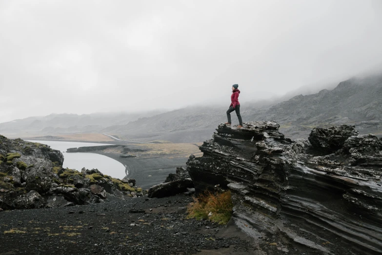 a person on top of a cliff in the mountains