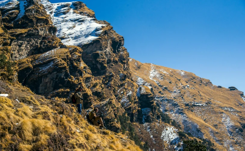 a mountain climber climbs on a trail