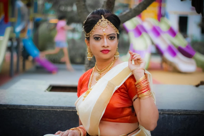 a girl dressed in a traditional outfit posing