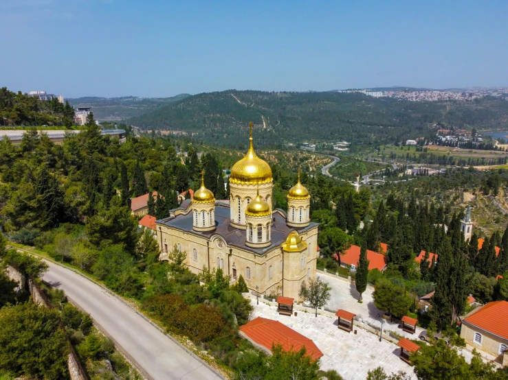 an aerial view of a church in the woods