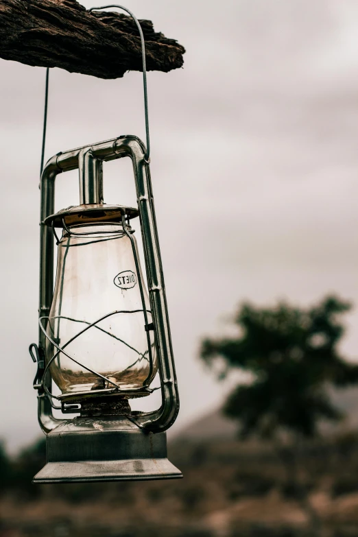 a lantern is hanging from a wooden nch
