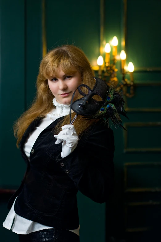 a young redhead dressed in a tuxedo and white gloves