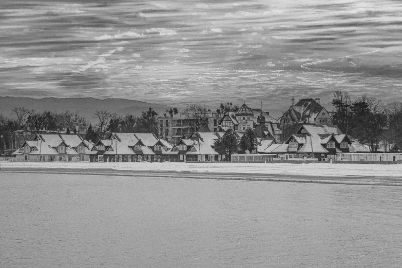 an old picture of houses in a snow covered field