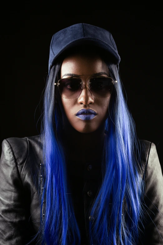 woman with blue hair and sunglasses and black hat