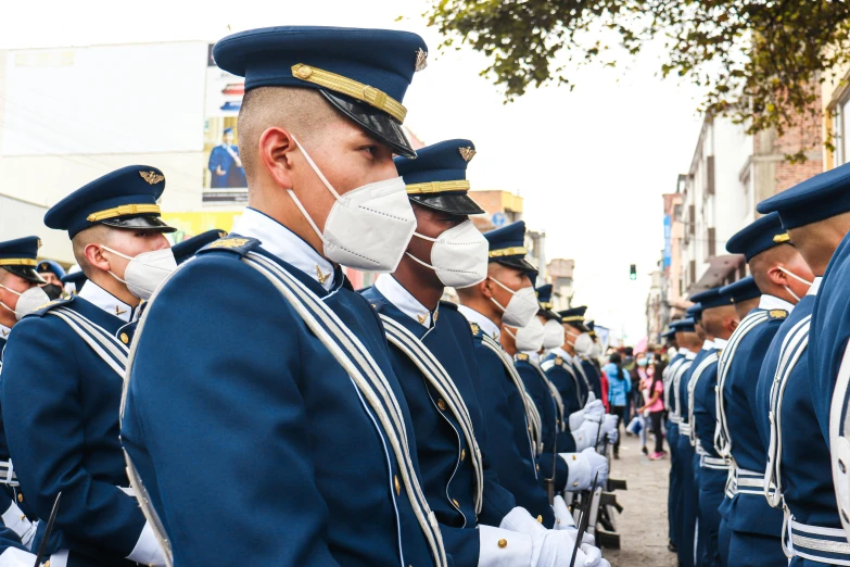 a row of military men in uniforms and masks