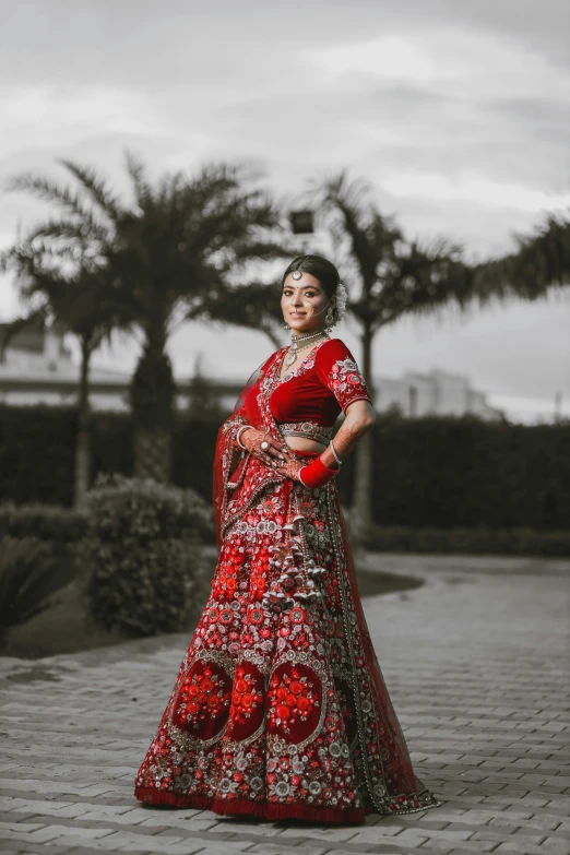 a woman in an indian dress and a tree