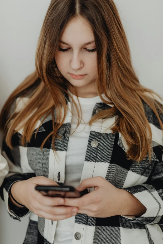 a young woman is texting on her cell phone