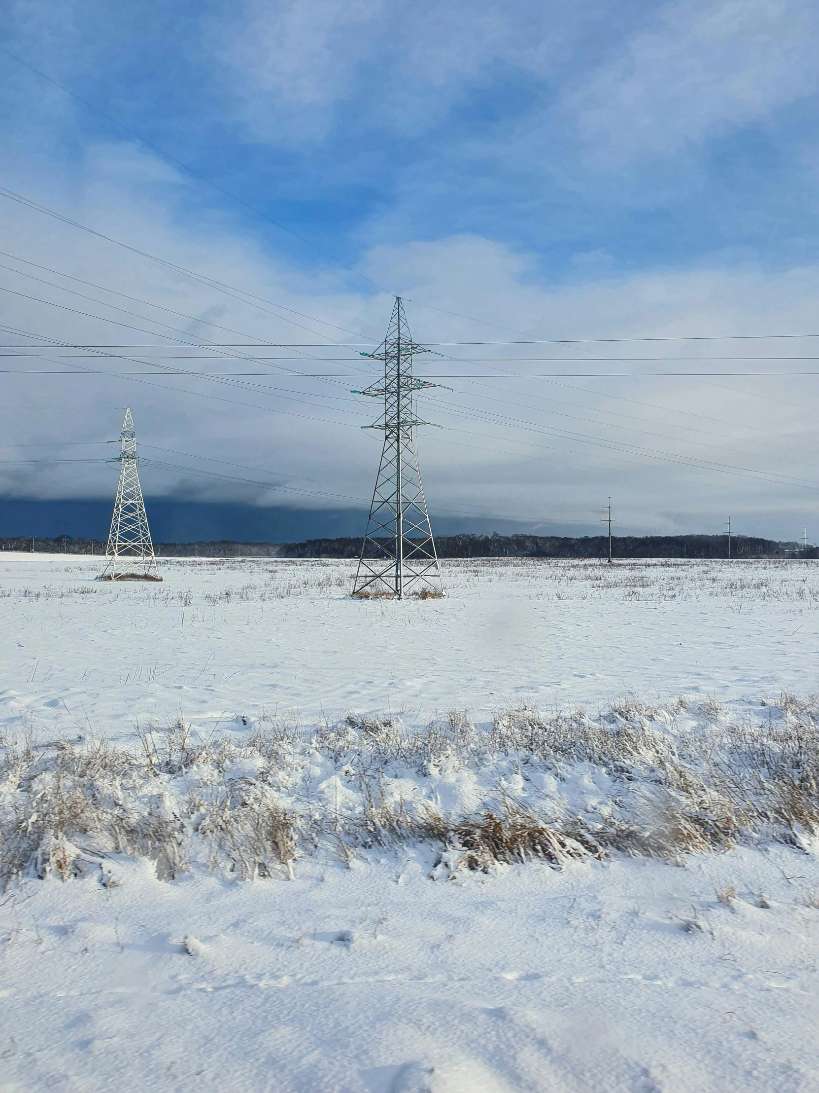 an icy field covered in snow and electrical wires