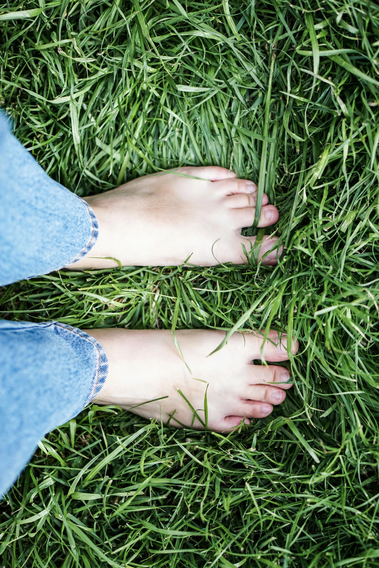 the foot of a person standing in some grass