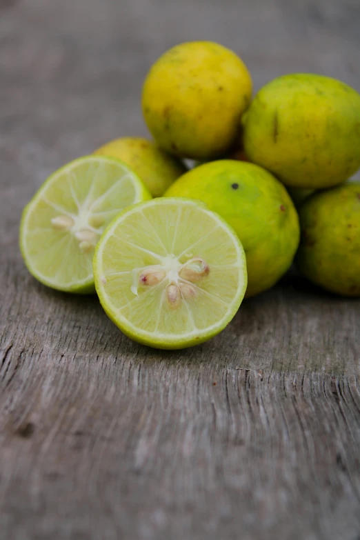 several limes and three lemon halves are shown