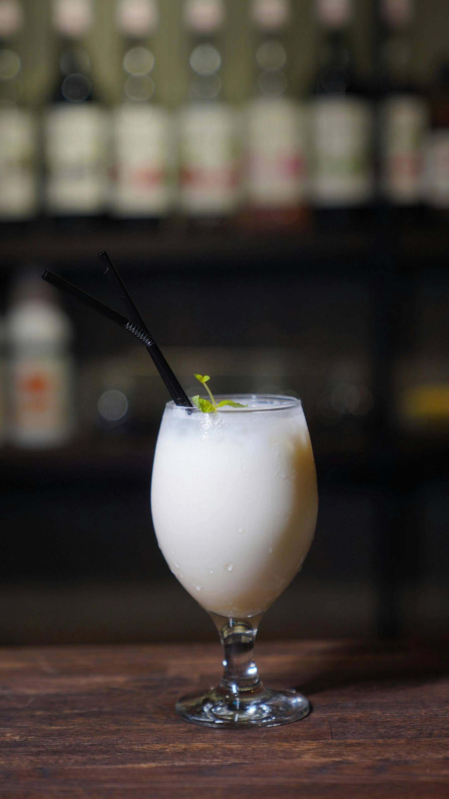 an oatmeal and sour cream soda cocktail is sitting on a wooden table