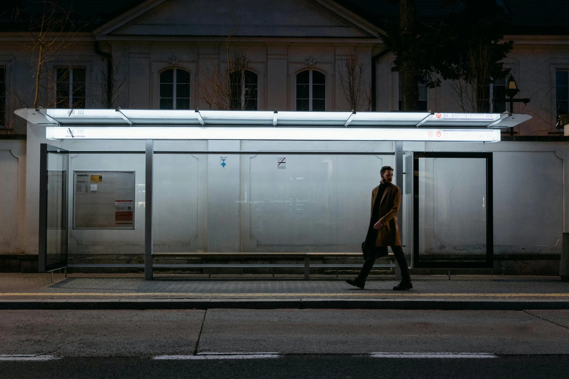 a man walking down the street at night