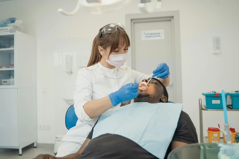 a dentist in a white coat with surgical equipment on