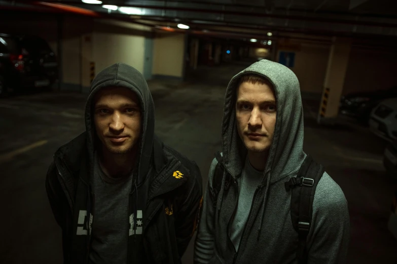 two men are wearing sweatshirts and jackets