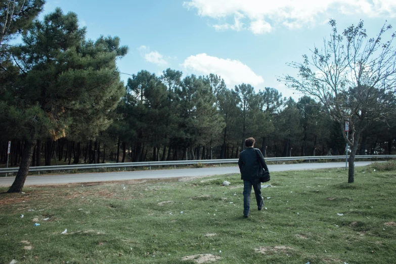 a man in a park is watching the road