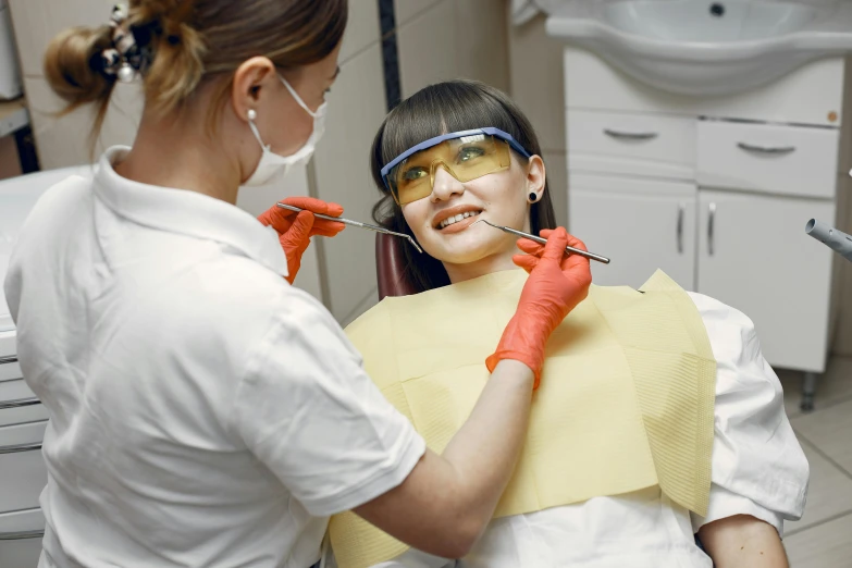 a dentist shows another woman how to fix her ces