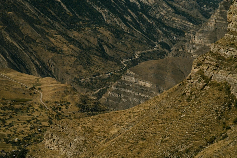 a large valley surrounded by rocky mountains on a hill top