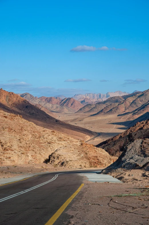 an empty road winding into the desert