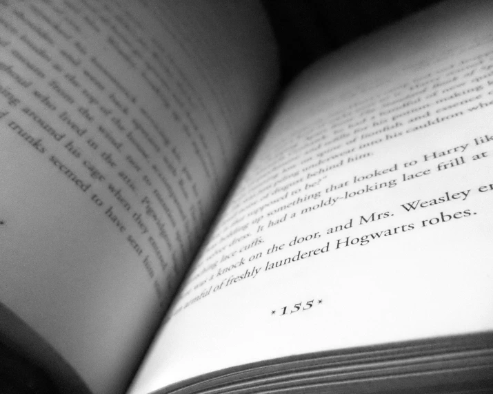 an open book is shown in black and white