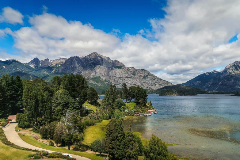 a body of water surrounded by mountains on a cloudy day